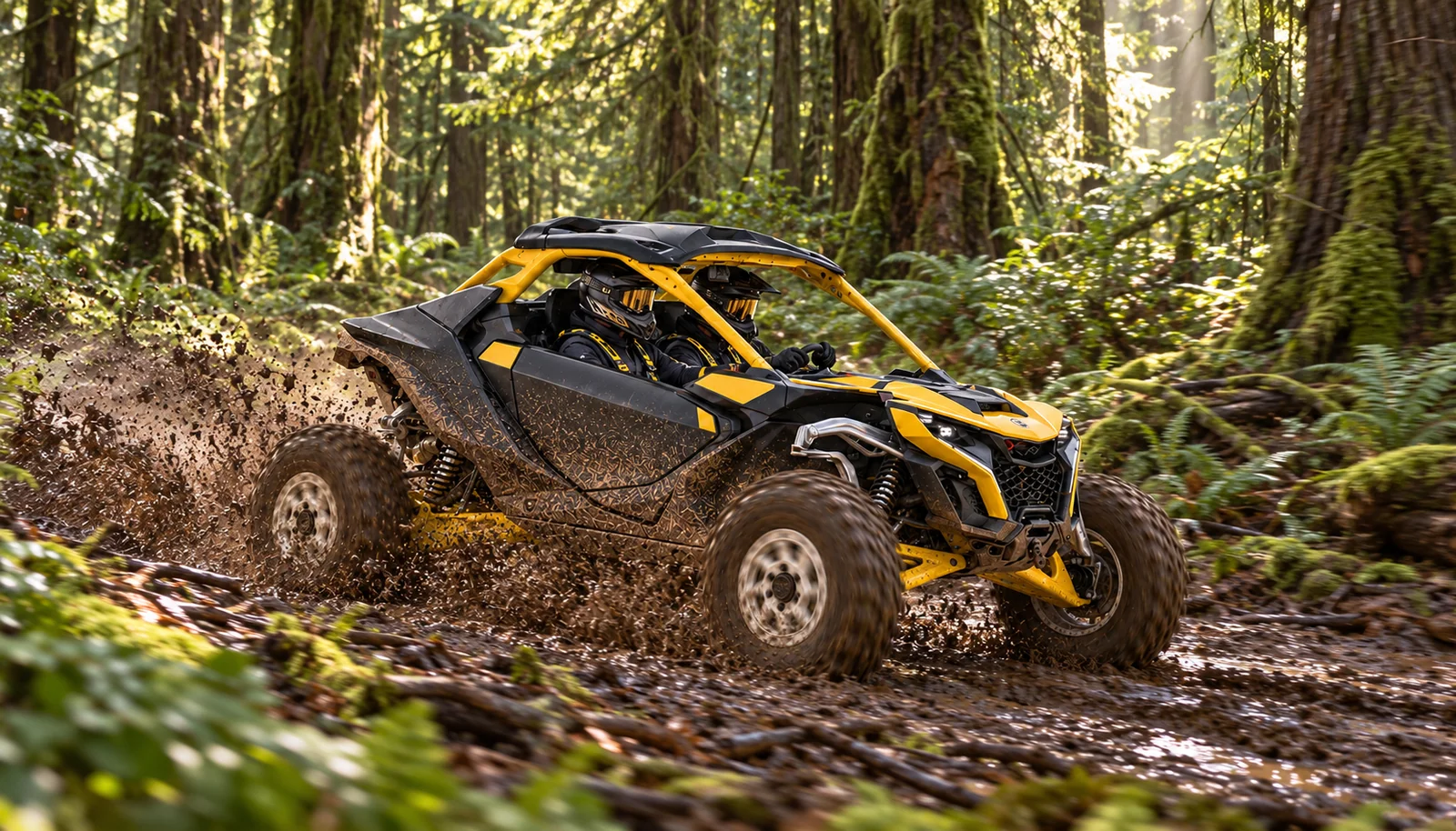 A two-seat Can-Am Maverick R splashes through mud on a rutted forest trail.